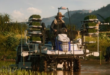 A farmer riding a machine in Farming Simulator 25