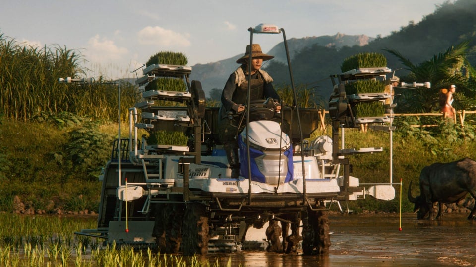 A farmer riding a machine in Farming Simulator 25