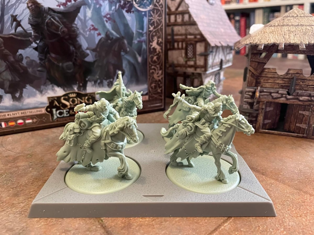 An image of Harma's Vanguard from A Song of Ice and Fire TMG featuring gorgeous sculpted plastic miniatures in a green-gray plastic, depicting Free Folk on horseback Game of Thrones