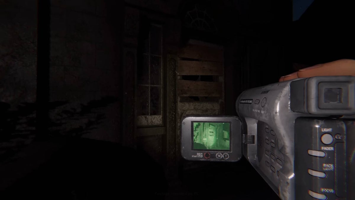 A player using a camera to view a dark environment in Phasmophobia