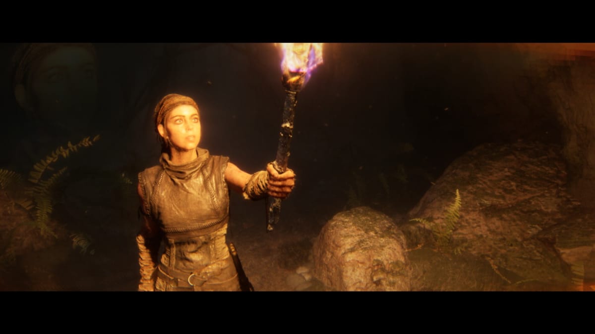 Senua holds a torch in Senua's Saga: Hellblade II