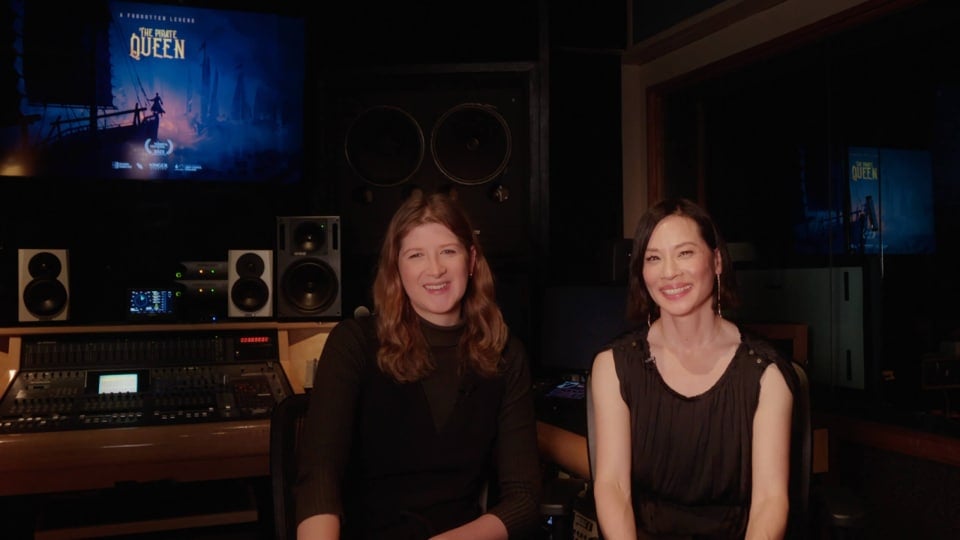 The Pirate Queen's director and star Eloise Singer and Lucy Liu sitting in a recording room