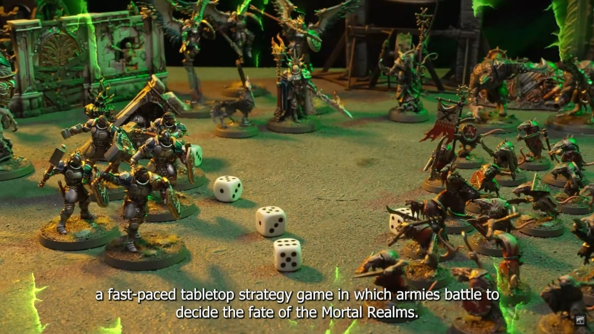 A screenshot from the Warhammer Age of Sigmar how to play video, showing miniatures on a battlefield, dice are seen in the background.