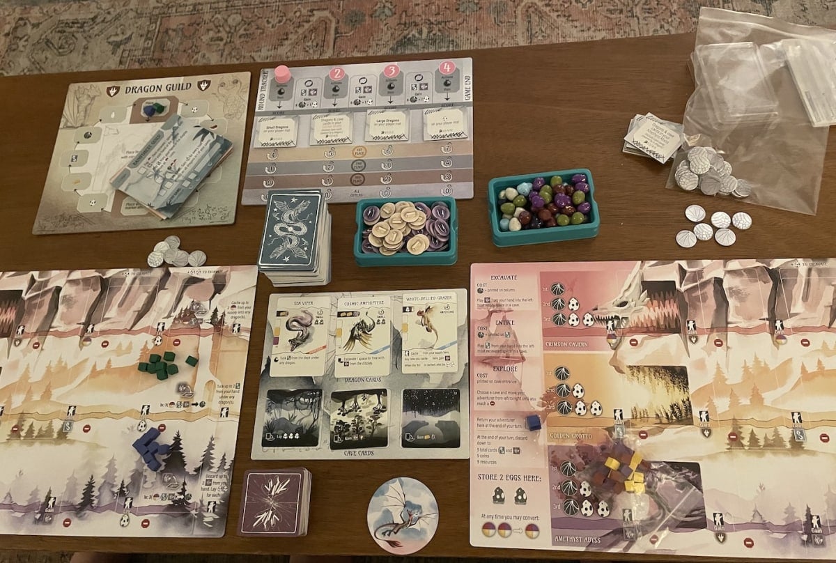 An image from our Wyrmspan Review featuring the full game board of cards, boards, and other elements on a coffee table.